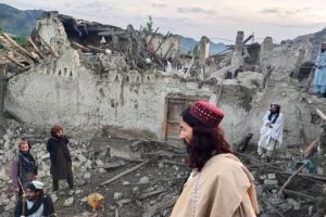 Man in red hat near destruction - Al Jazeera